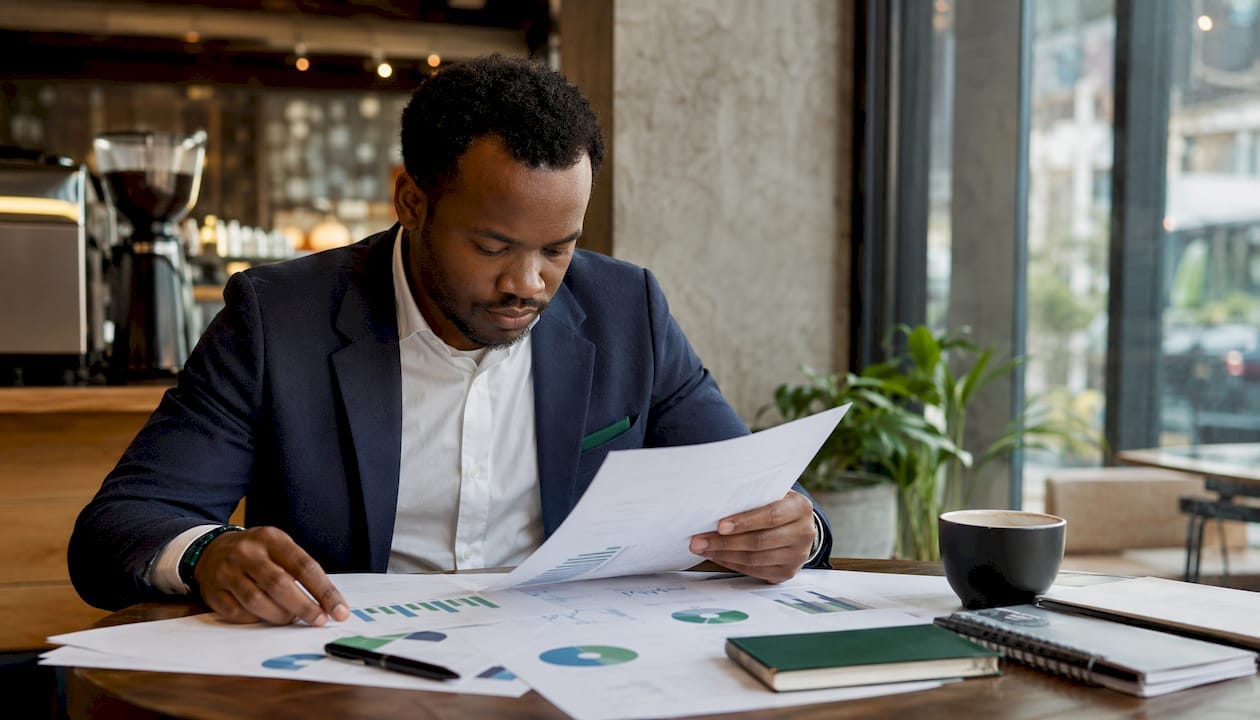 Hands reviewing ROI charts for automation